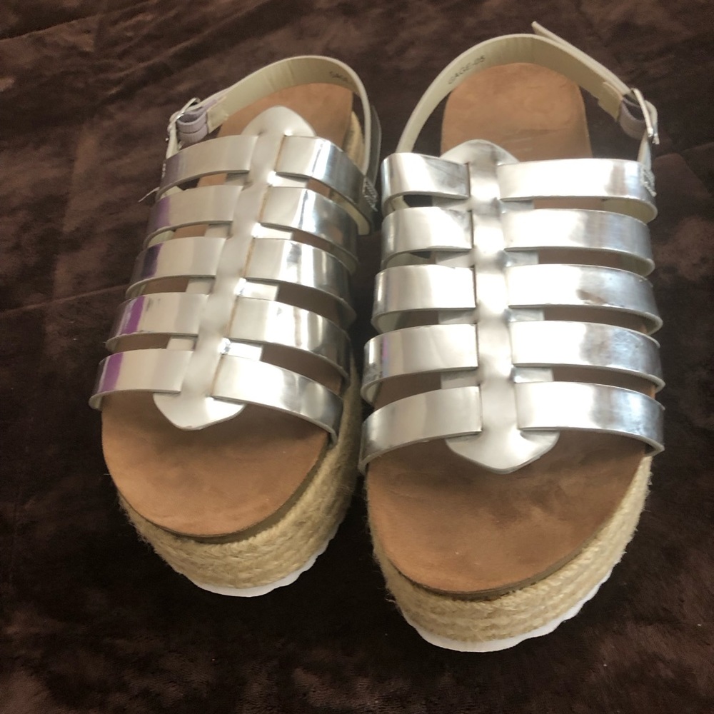 A Women’s silver size 8 gradiator espadrille platform sandals